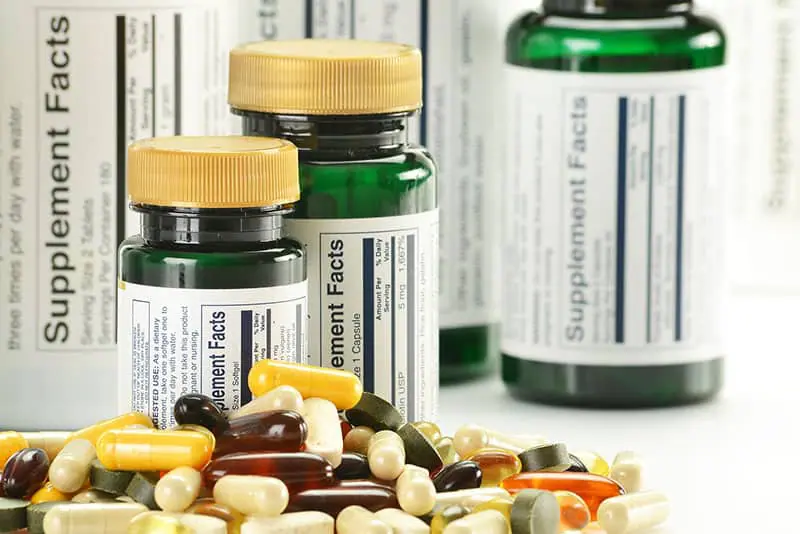Dietary-Supplement Dietary supplement capsules and vitamins on white background