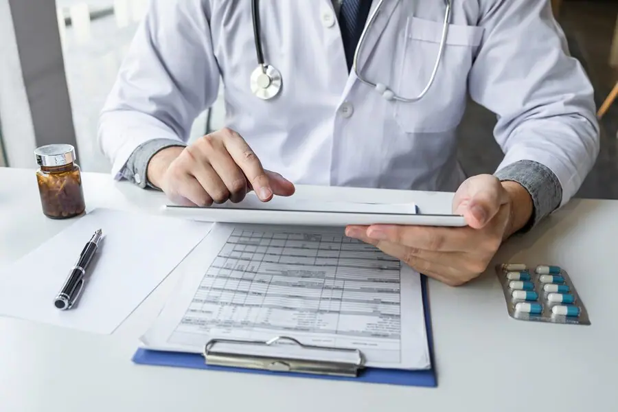 doctor-working-using-digital-tablet-note-information-paper-report-hospital-medical-stethoscope-medicine-clipboard-desk_229060-393